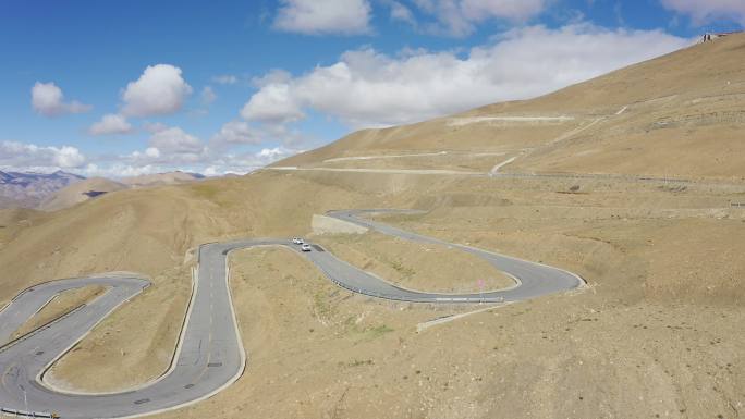 航拍越野车行驶在西藏珠峰108拐盘山公路