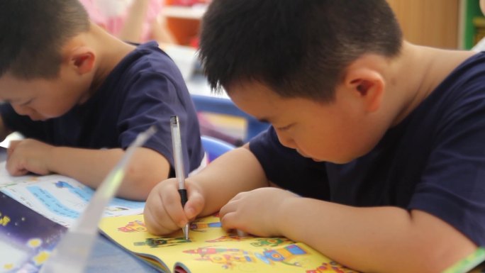 幼儿园孩子在教室里读书写字