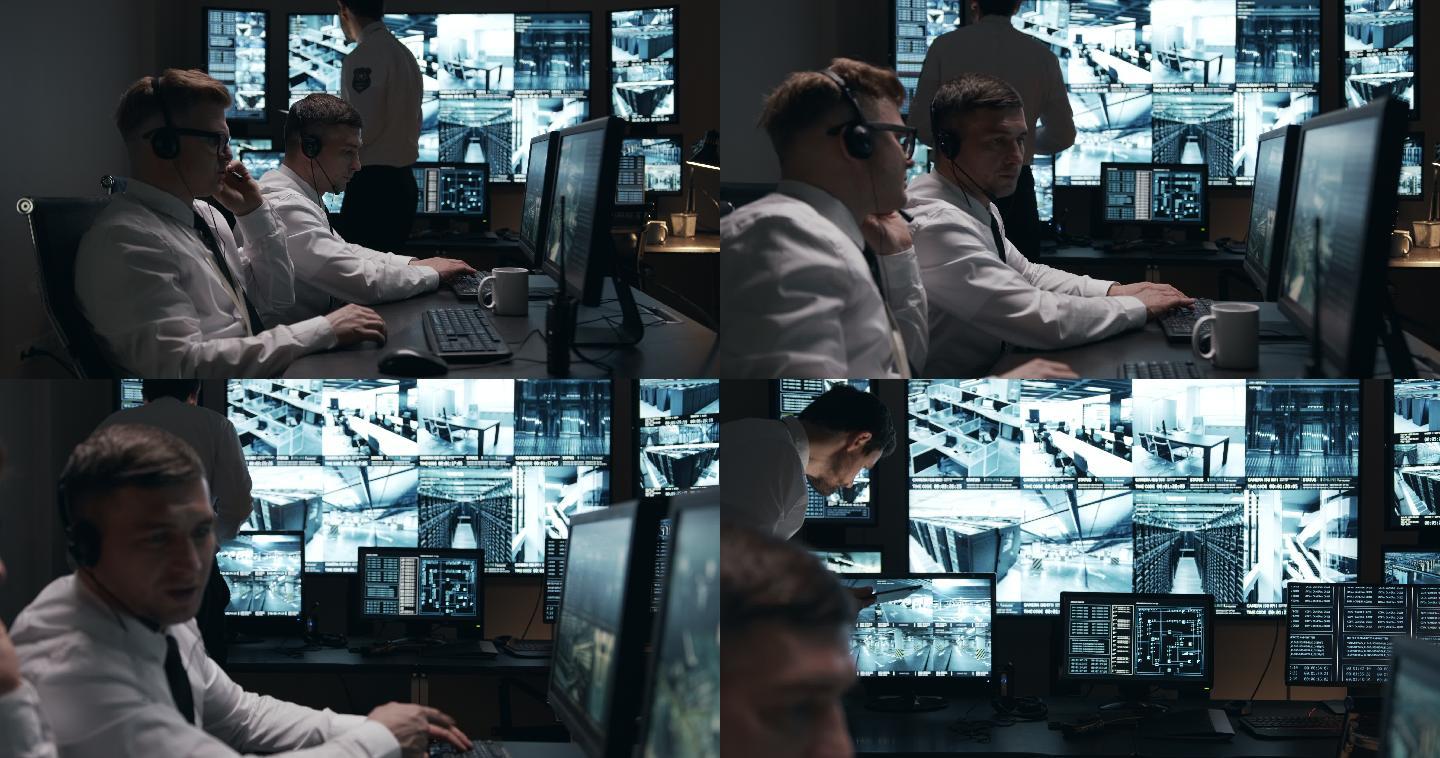 两名保安正全神贯注地在电脑前工作，第三名保安正在平板电脑上阅读新闻