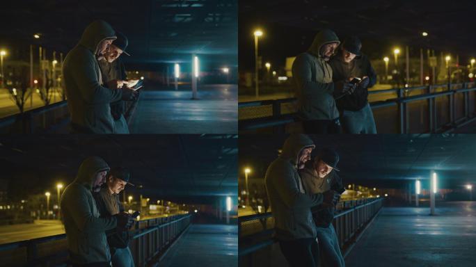 SLO MO两个歹徒晚上在城里使用智能手机