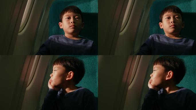 一个男孩坐在商用飞机旁的窗户上。他坐在那里望着窗外的景色。带着能坐飞机旅行的兴奋。