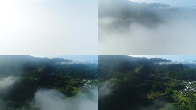 航拍穿越厚重云层出现山林及村落