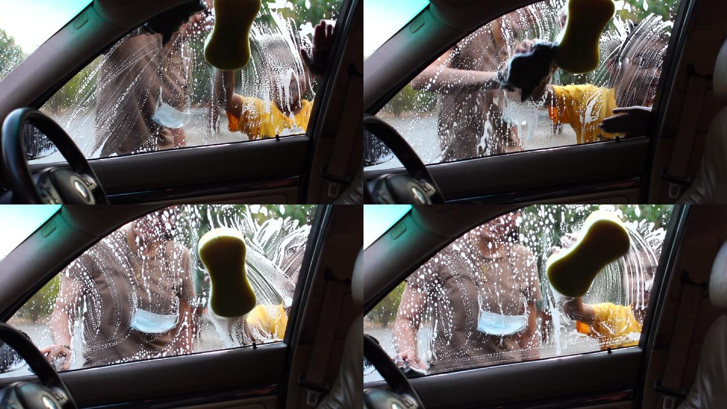 快乐的亚洲家庭一起洗车。慢镜头