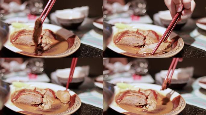 用筷子抓烤鸭的手的特写镜头
