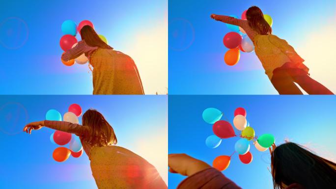 SLO MO女孩向天空释放了一束彩色气球