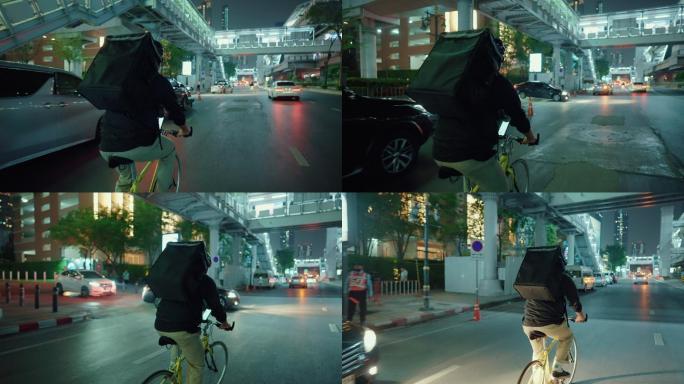 自行车送货员在城市的夜晚四处奔波。
