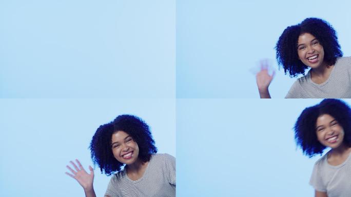 一个漂亮的年轻女子在蓝色背景下挥手的4k视频片段