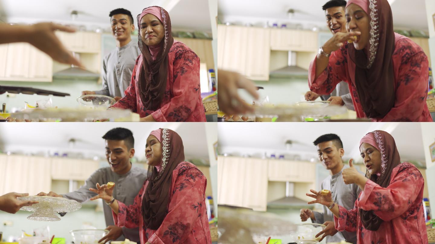 马来西亚马来族母亲和儿子女儿在厨房品尝自制饼干