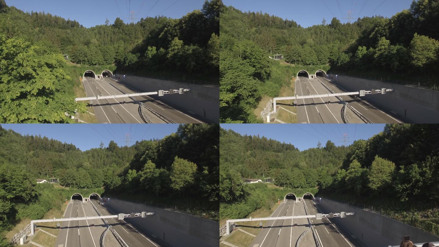 无人机俯瞰高速公路，汽车驶入隧道