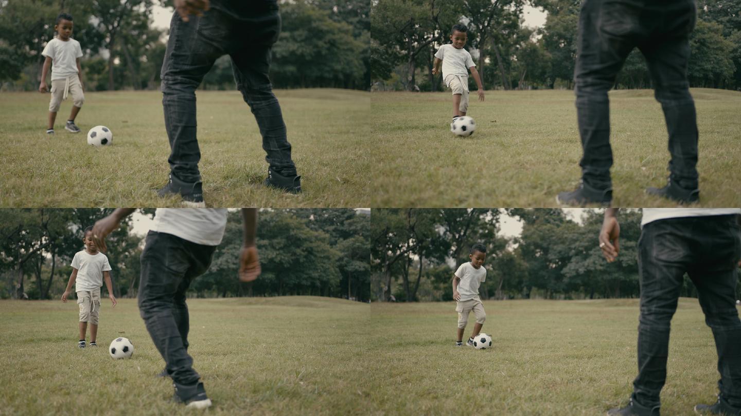 慢动作：爸爸和儿子玩足球