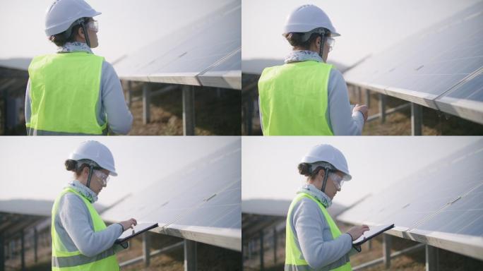 可再生能源系统。太阳能电池板。在太阳能发电站现场工作的维护工程师。