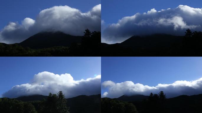 蓝天下厚重乌云爬过山头