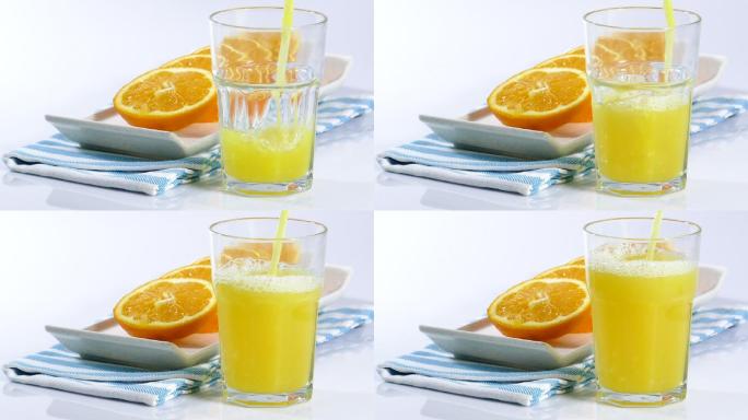 把橙汁倒进杯子里橘子汁素材