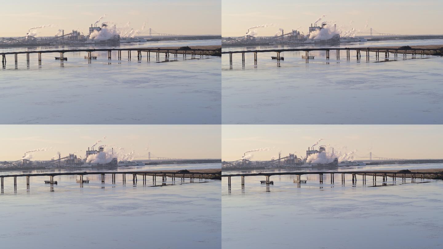 美国佐治亚州不伦瑞克附近东河上一家大工厂的鸟瞰图。无人机用电影般的前进和平移镜头拍摄了画面。