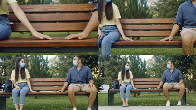 一对戴着防护口罩的斯洛莫年轻夫妇坐在公园的长椅上，双手张开
