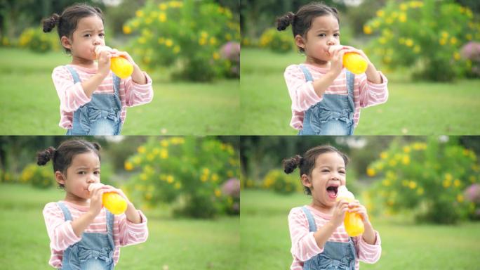 喝橙汁的小女孩小孩喝果汁