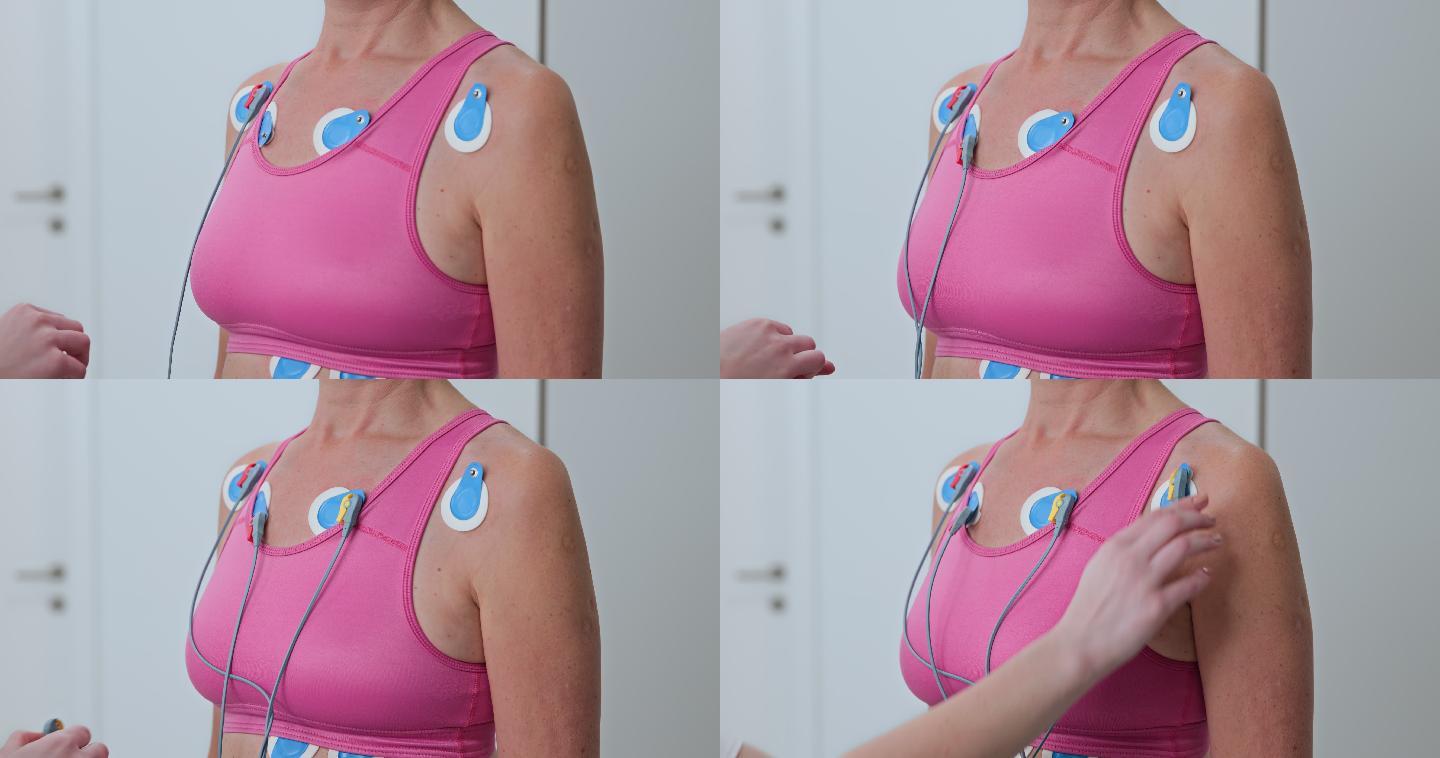 LD女护士在一名女性的胸部放置电极