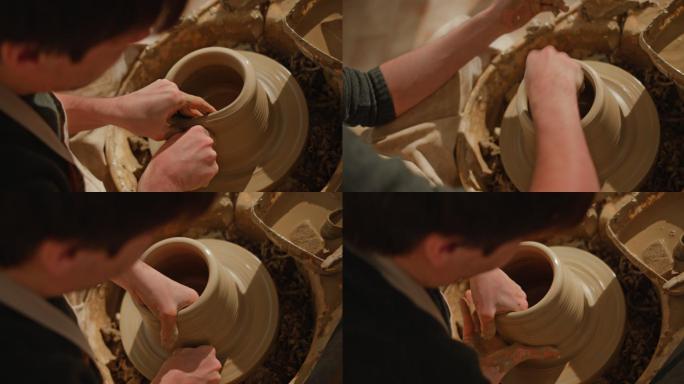 男陶工在陶工的轮子上举起壶壁
