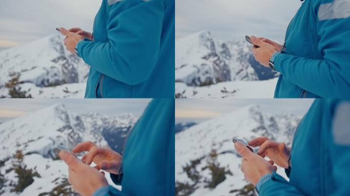 在雪山上使用手机的男子