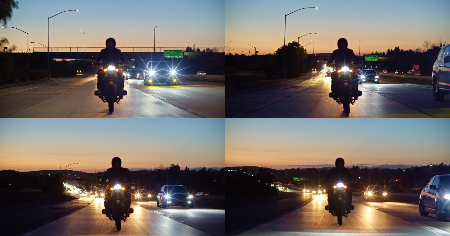 日落时分，一个骑摩托车的人在摩尔帕克高速公路上行驶