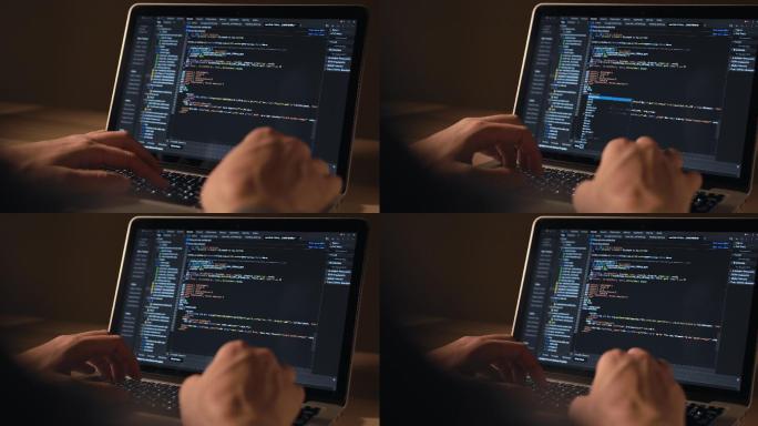 男人的手在笔记本电脑上编码特写。人类使用便携式电脑。程序员写代码