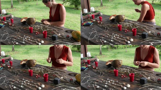 年轻女子在野餐桌上做贝壳编钟