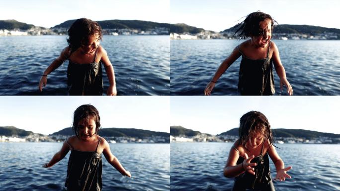 夏天在海上洗完澡后，一个小女孩在摇水