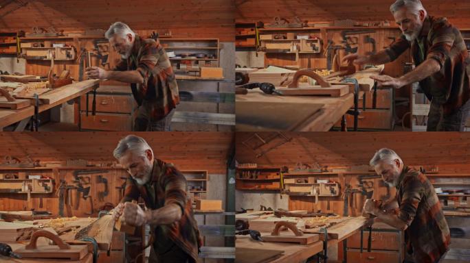 高级男木匠在他的店里用刨子把木板刨成方形