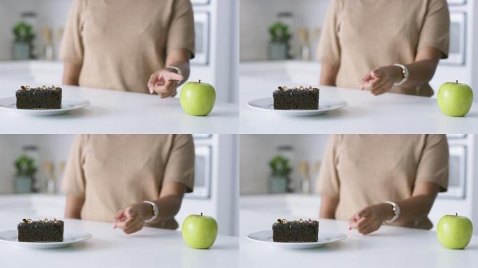 一段4k视频，一位面目全非的女士决定在家里吃苹果还是巧克力布朗尼