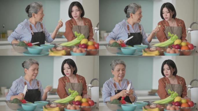 亚裔华裔美女和她的母亲在厨房柜台为家人做饭