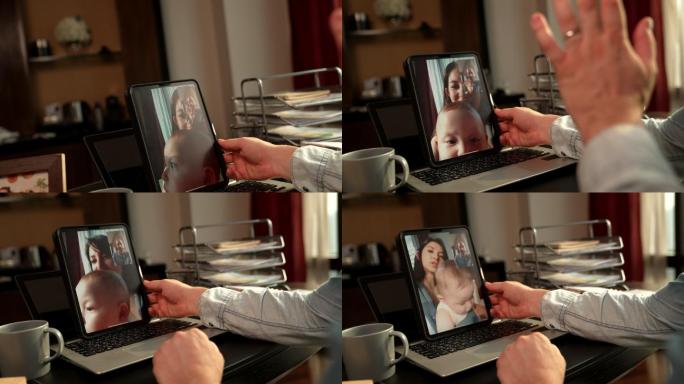 爸爸正在和一位用平板电脑抱着婴儿穿过屏幕的妈妈交谈。在每个人都必须适应2019冠状病毒疾病流行的时代