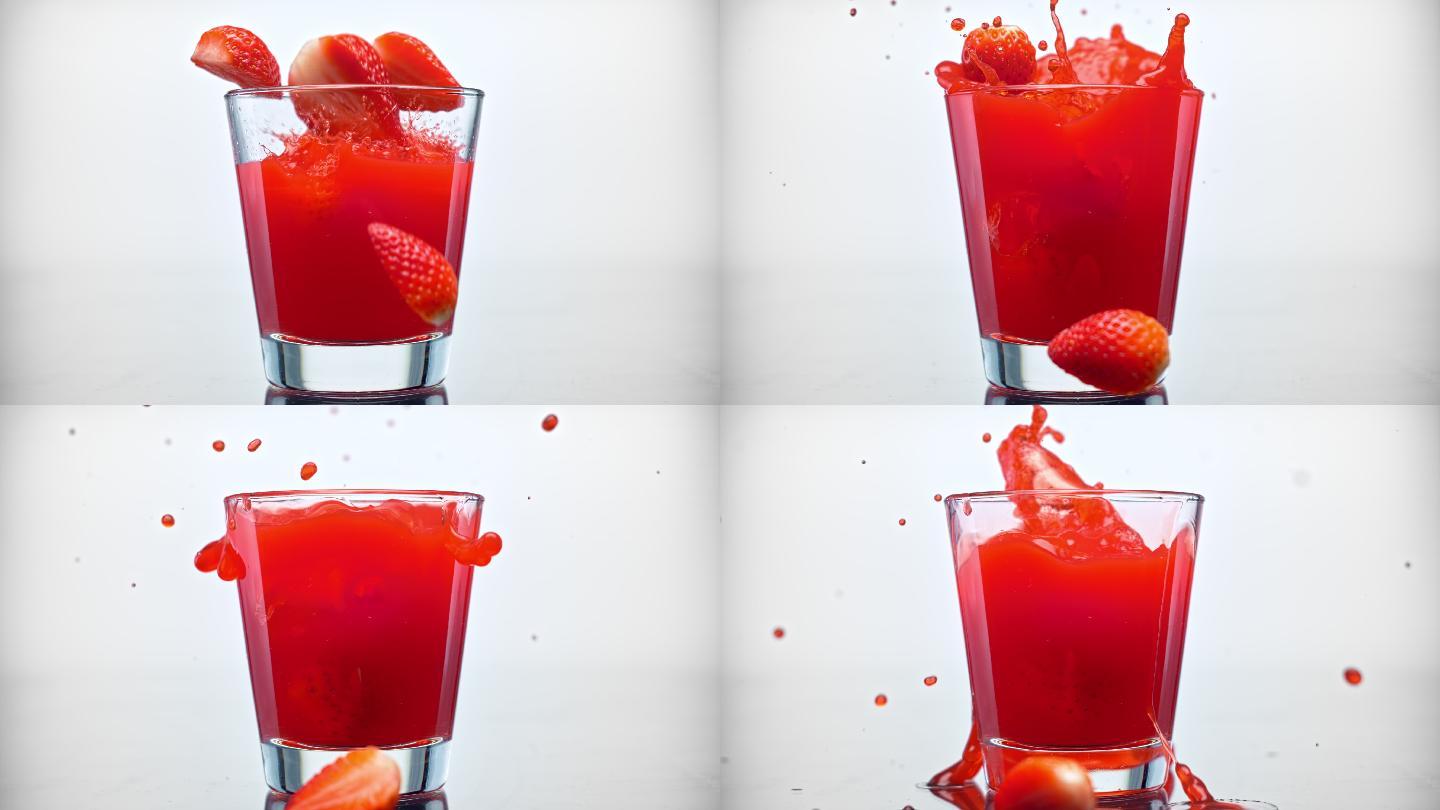 草莓的一半掉进一杯果汁里