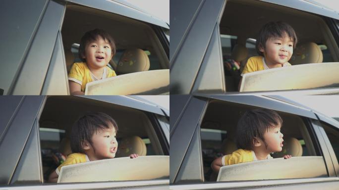 亚洲男婴微笑着从车窗向外看