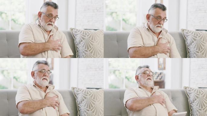 一名老年男子坐在家中时胸痛的4k视频片段
