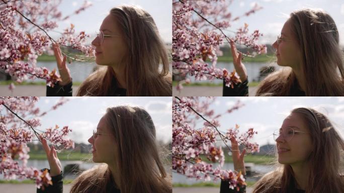 少女在美丽的樱桃树上欣赏春花