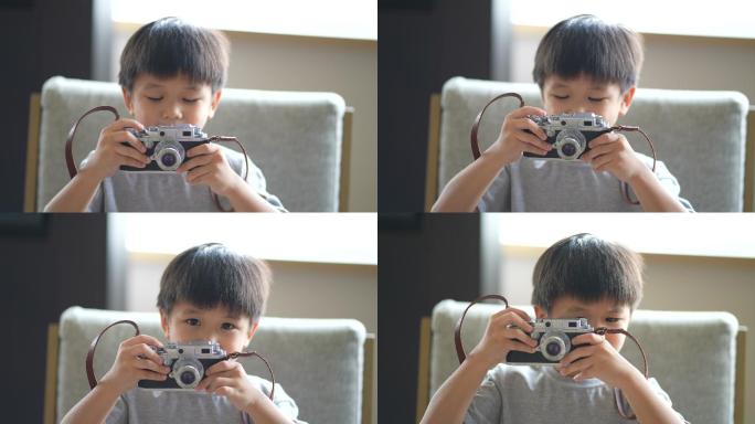 亚洲小孩用老式相机拍照