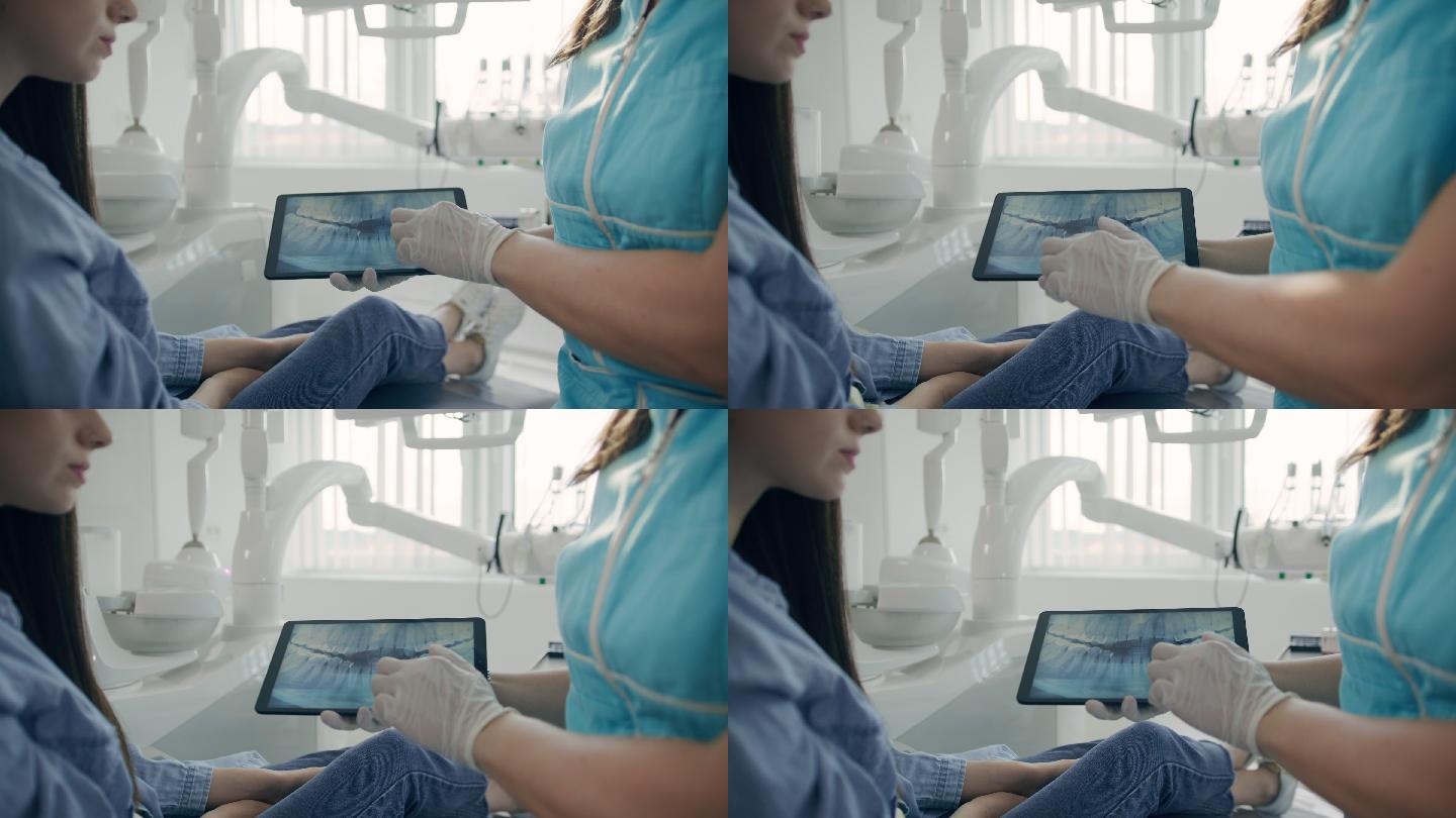 MS牙医向一名女性患者展示数码平板电脑上的X光片