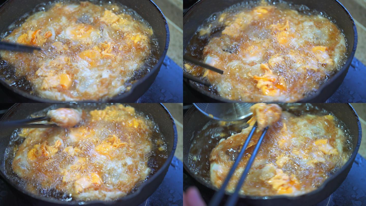 厨房里一位厨师在用油锅制作炸蛋 油炸鸡蛋