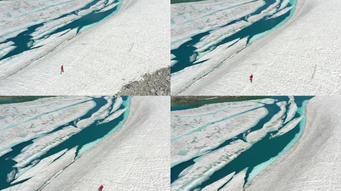 鸟瞰尖峰和被浮冰覆盖的绿松石湖。探索极端地形的女人