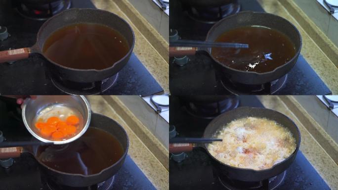 厨房里一位厨师在用油锅制作炸蛋 油炸鸡蛋