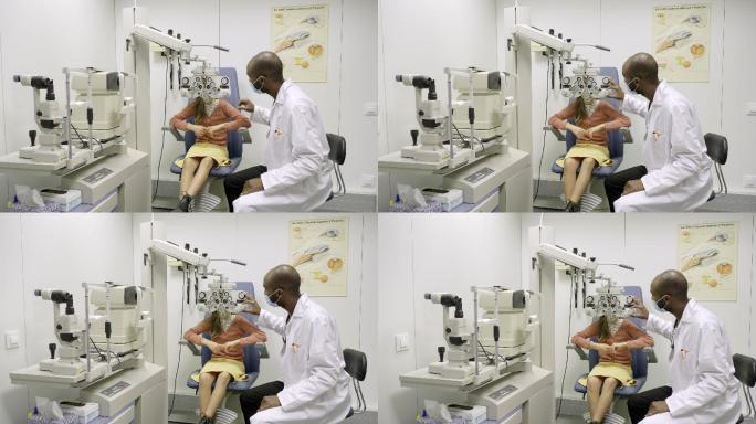 眼科医生在诊所为一名年轻女孩做视力检查