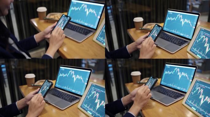投资者正在交易股票。在电子市场上通过电脑通过手机上网。