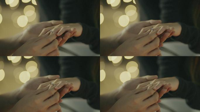 男人把戒指戴在女友的手指上