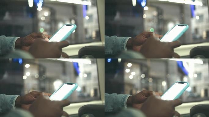 4k视频片段，一名无法辨认的男子在公交车上使用智能手机