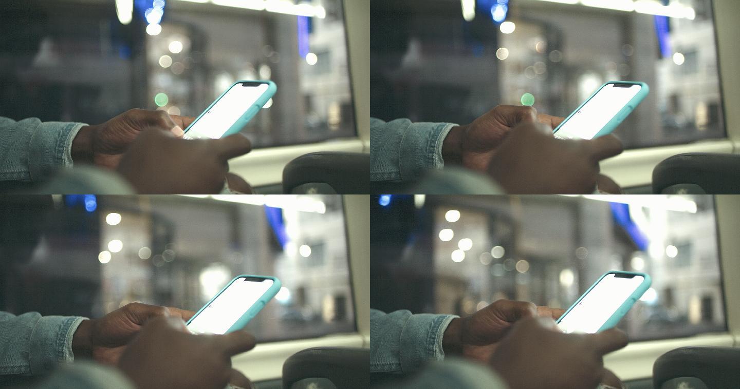 4k视频片段，一名无法辨认的男子在公交车上使用智能手机