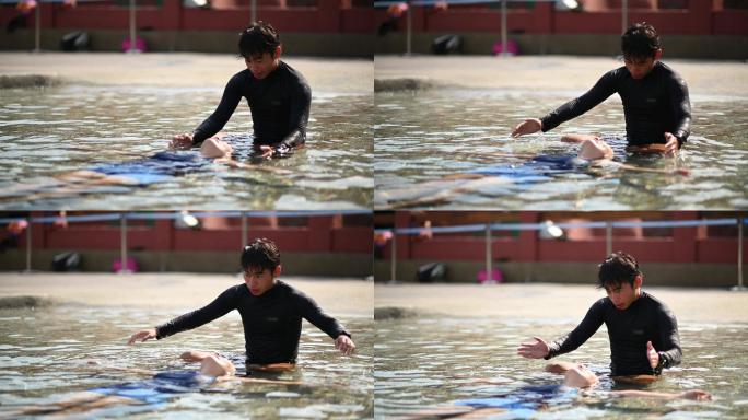 亚裔中国男游泳教练指导他的学生在游泳池中漂浮在水面上