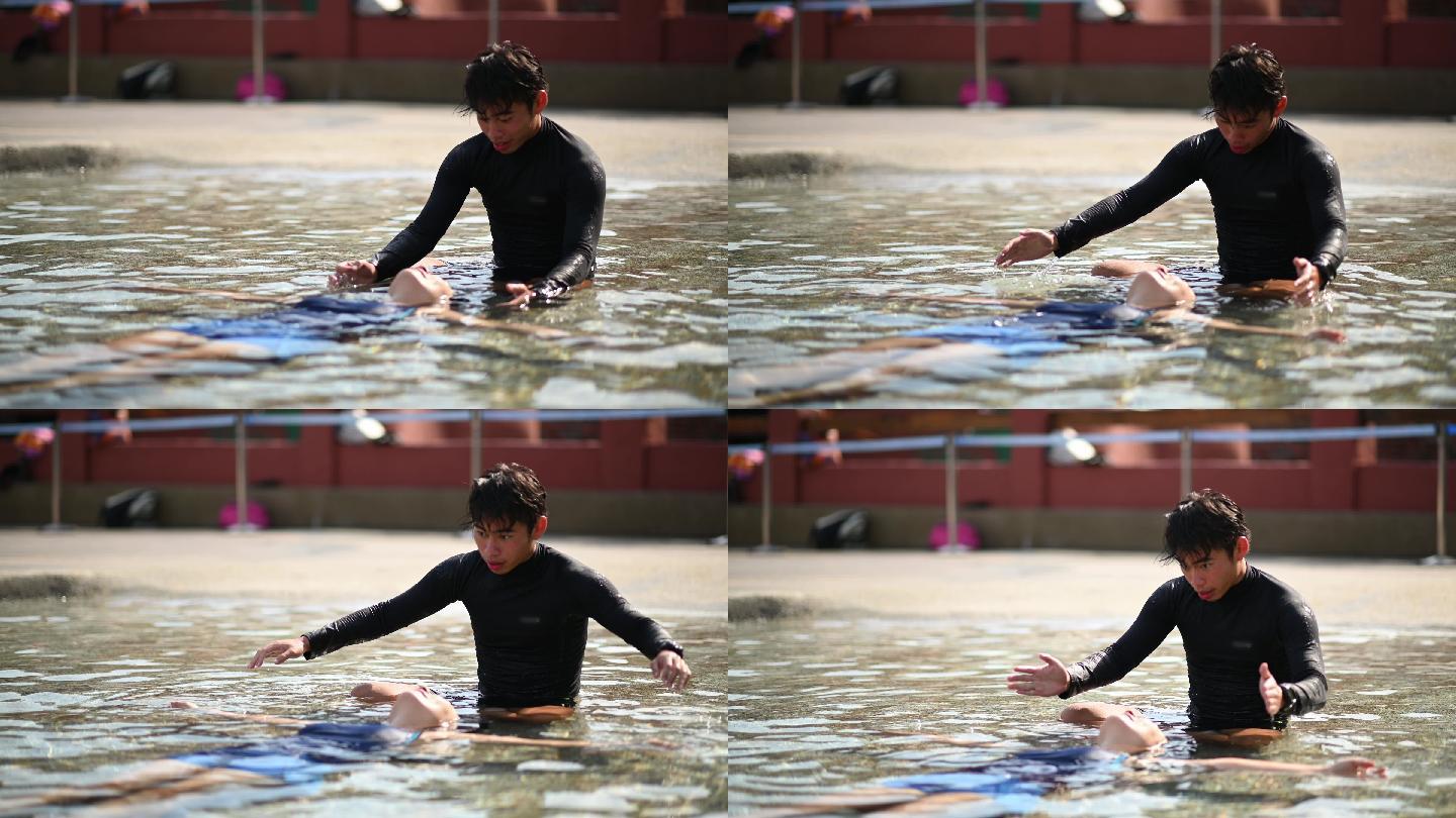 亚裔中国男游泳教练指导他的学生在游泳池中漂浮在水面上