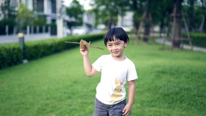 玩纸飞机的亚洲可爱男孩