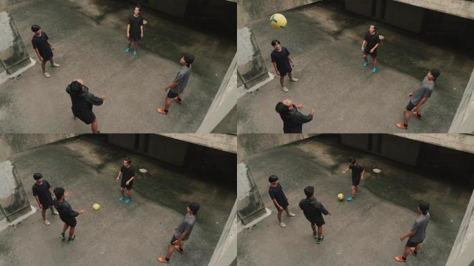 年轻的亚洲男子正在踢足球