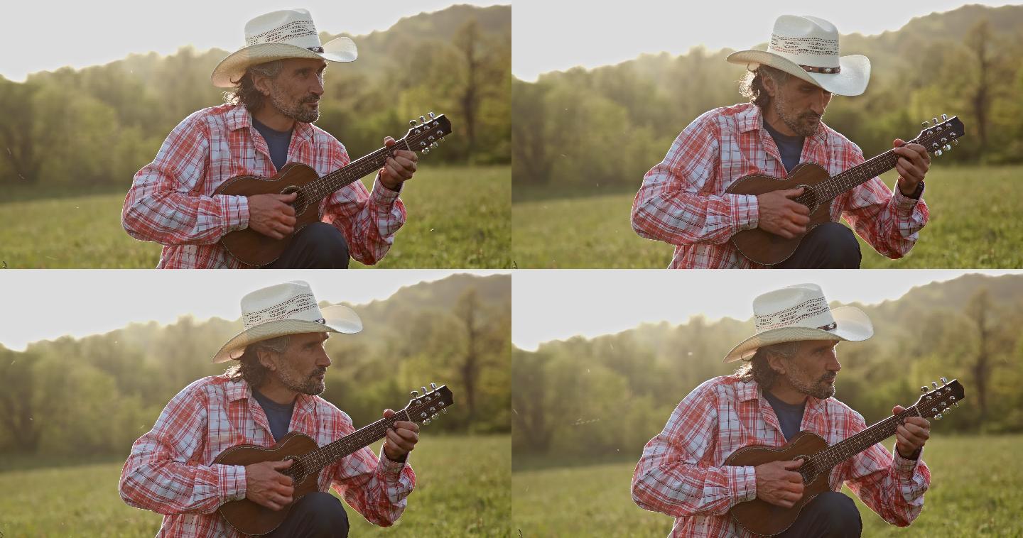 大自然中的牛仔在日落时弹吉他。春季度假。